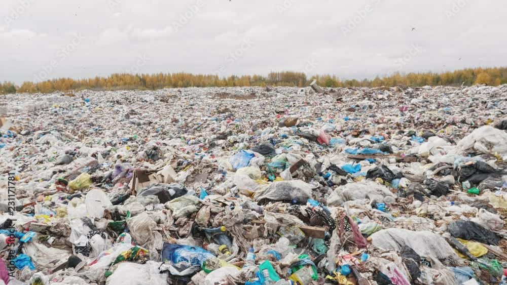 Handheld shot of city garbage dump, environmental pollution due to lack of recycling technology Handheld shot of city garbage dump, environmental pollution due to lack of recycling technology