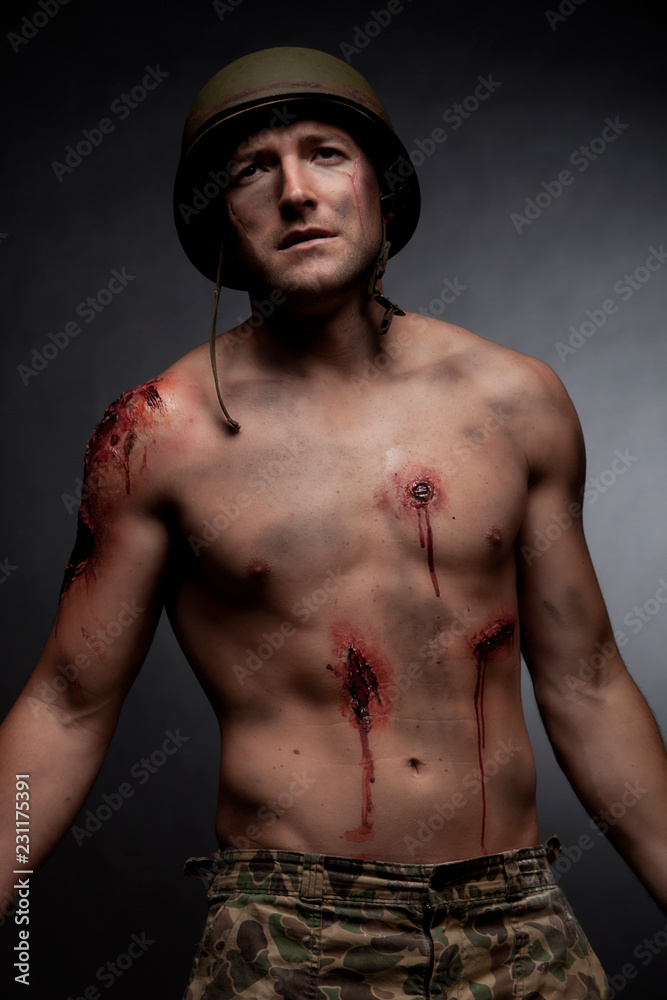 a military soldier struggles show his scars on his face and body