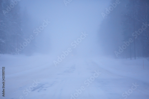 snow and fog on the winter road landscape / view of the seasonal weather a dangerous road, a winter lonely landscape © kichigin19