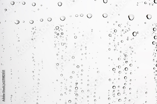 white isolated background water drops on the glass / wet window glass with splashes and drops of water and lime, texture autumn background