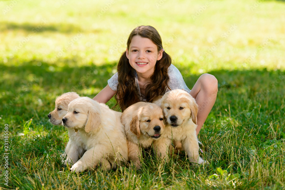 Child playing with puppies
