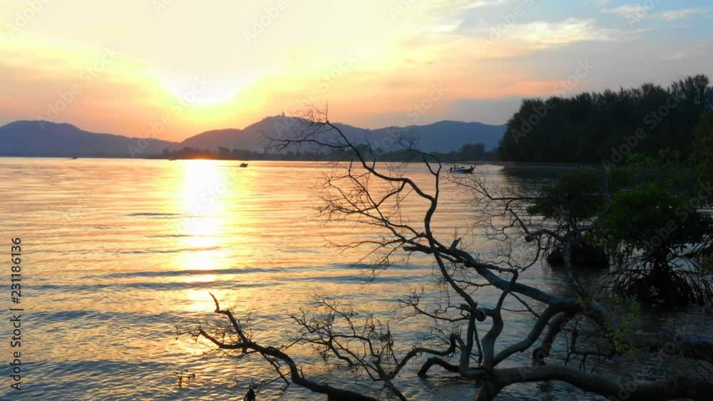aerial view sunset in Mudong canal conect to Chalong bay. Klong Mudong canal has perfect mangrove forests..from here can see the Phuket big Buddha statue on the top of mountain.