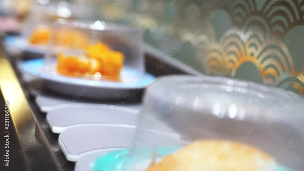 Close up of Sushi and rolls on plates moving around a sushi bar. 4k, 3840x2160 Close up of Sushi and rolls on plates moving around a sushi bar. 4k, 3840x2160