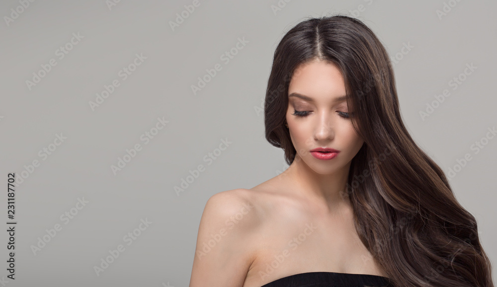 Portrait of a fashionable woman and long dark hair. Wavy shiny hair Portrait of a fashionable woman and long dark hair. Wavy shiny hair