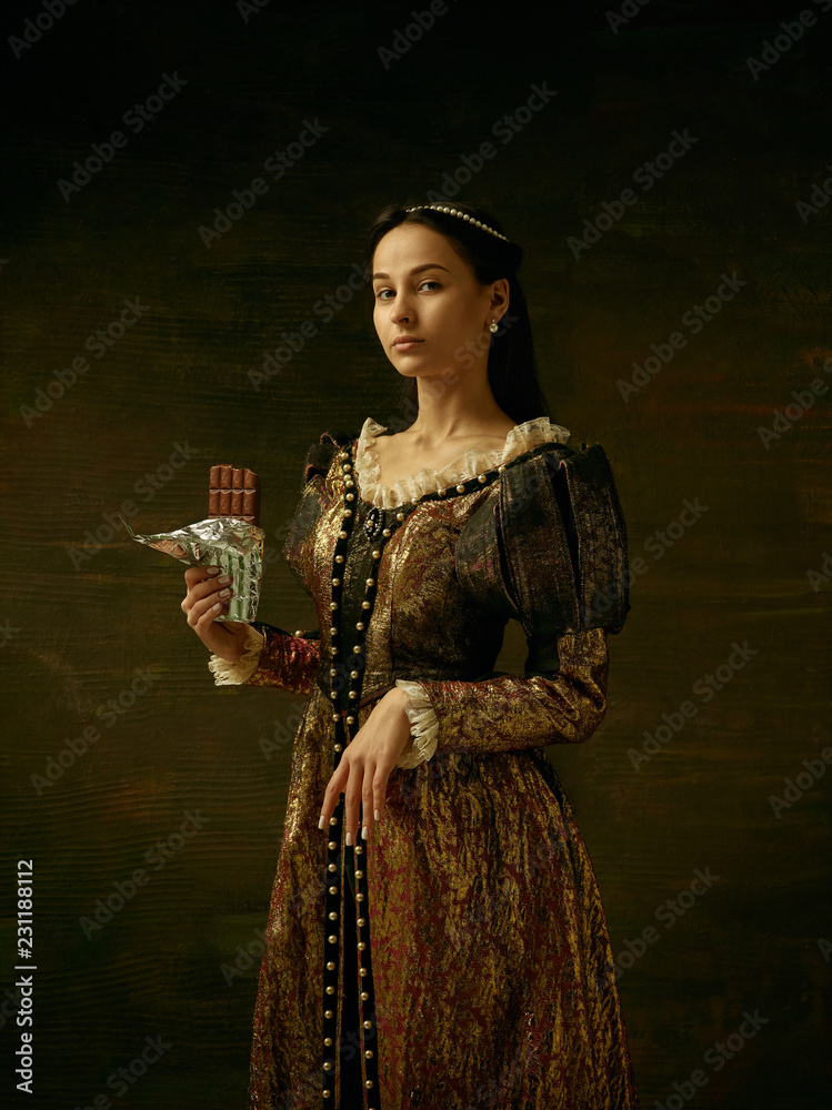 Fototapeta premium Girl in medieval beautiful dress or costume of the countess at dark studio.