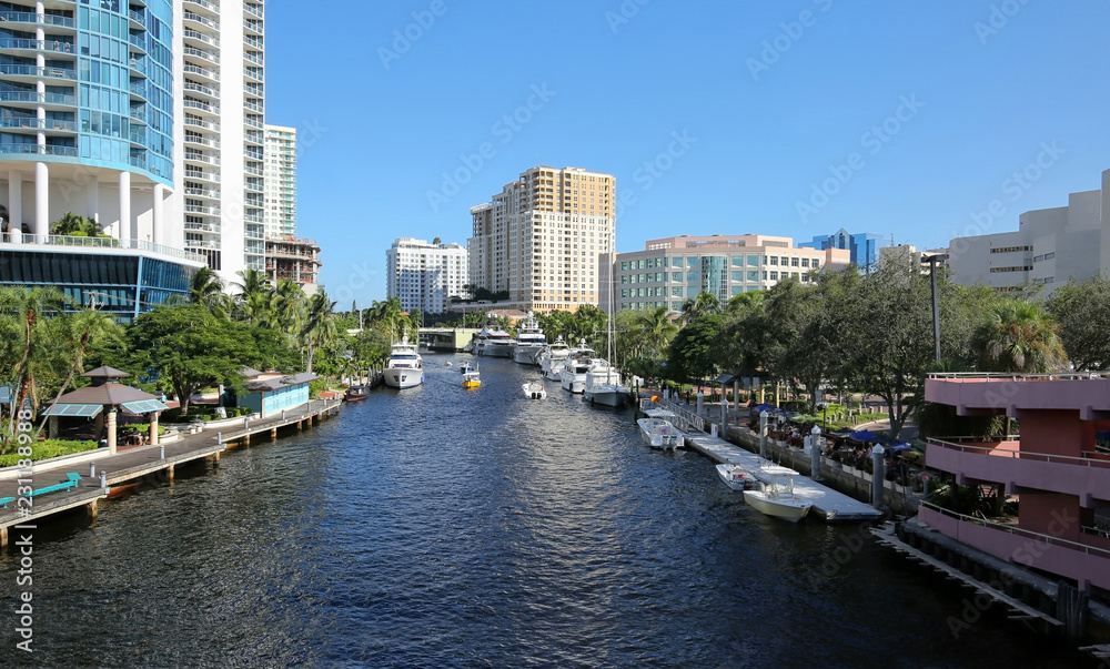 Skyline aerial view of downtown Fort Lauderdale   New River Waterways. Yachts and boats dock along the New River and next to Riverwalk a lush tropical riverfront park. 