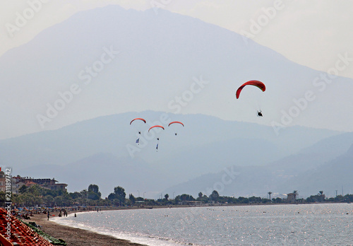 racing paragliders over the Mediterranean sea