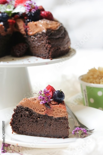 Homemade Chocolate Quinoa Cake topped with fruits and berries