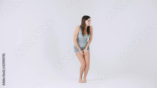 Beautiful girl really wants to use the toilet, suffers dancing funny, then runs to pee, women health photo