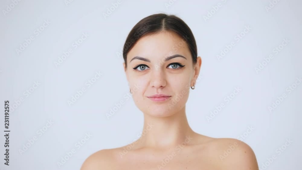 Close-up portrait of beautiful woman looking to camera with attractive smile. Beauty and skin care concept. Close-up portrait of beautiful woman looking to camera with attractive smile. Beauty and skin care concept.