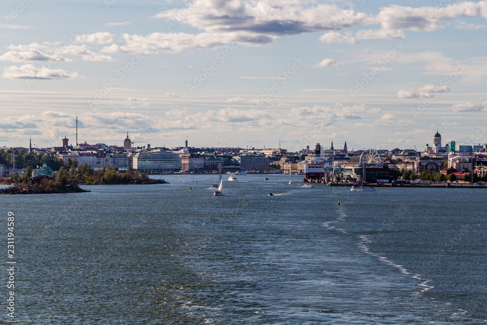 Helsinki city on summer with lots of smaller boats and a car ferry loading, Finland