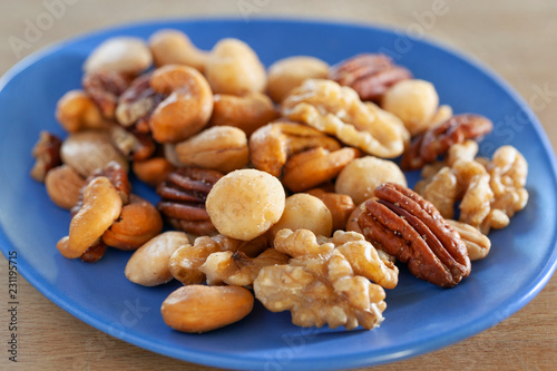 Salted nuts mix on a blue dish