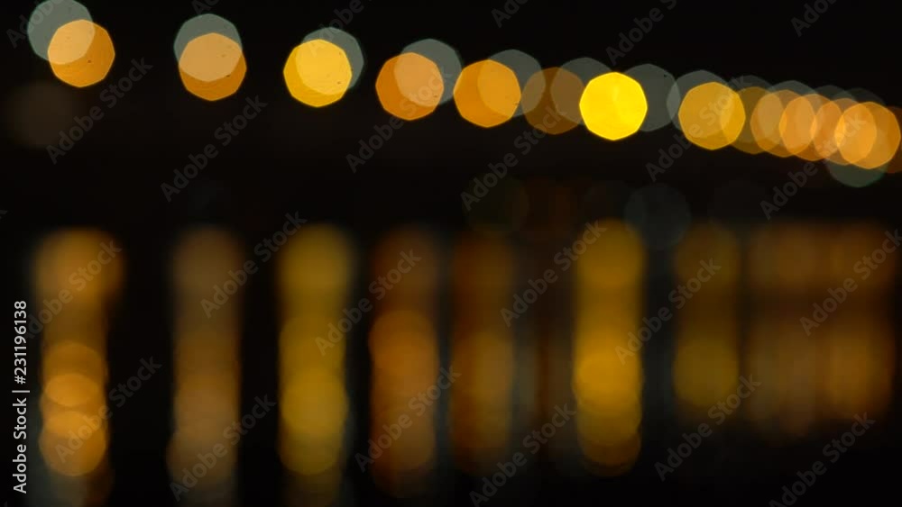 Abstract lights and their reflections in the water bokeh background