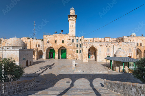 The minaret of a mosque in Old Jerusalem seen through an arch on the Haram es Sharif also known as the Temple Mount, Israel. photo