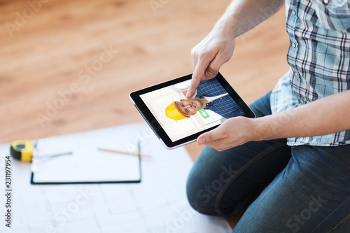 repair, building and technology concept - close up of man with blueprint and pencil having video call with builder or foreman on tablet pc computer