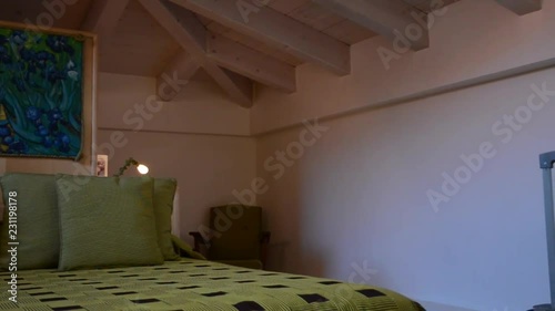 giovane donna cammina in una camera da letto in una mansarda photo