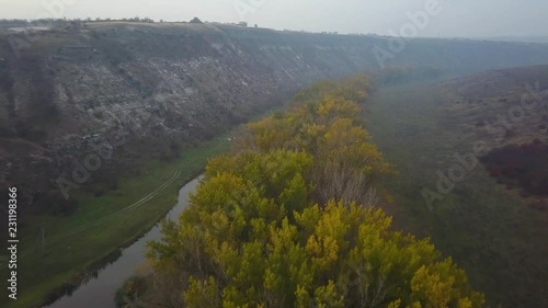 Beautiful sunrisw over river in rural area. Fog over small river. Mountains landscape. photo