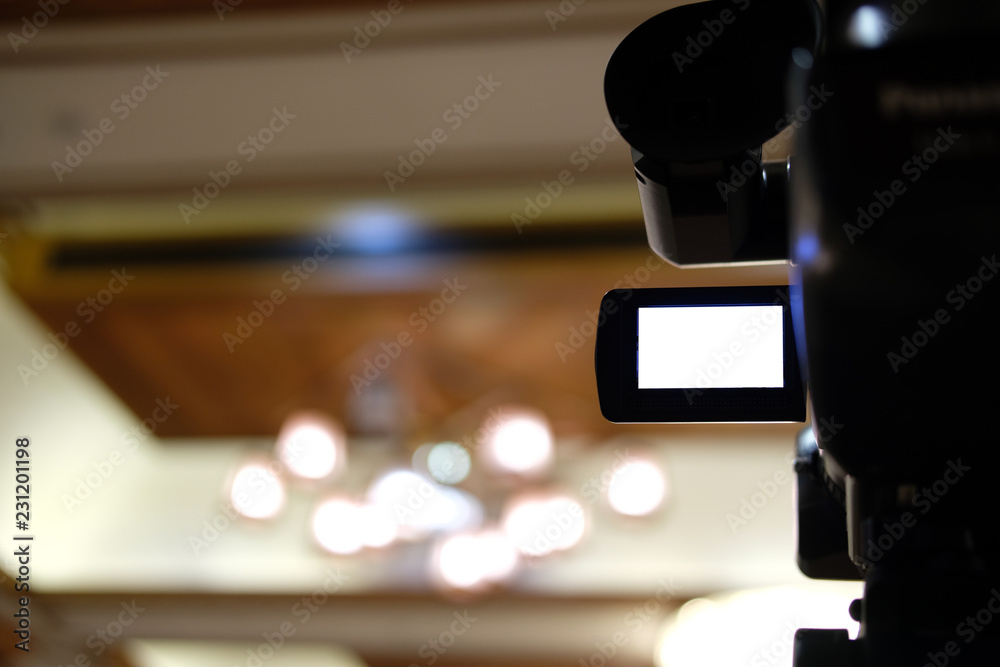 video production camera recording live event on stage. television social media broadcasting seminar conference