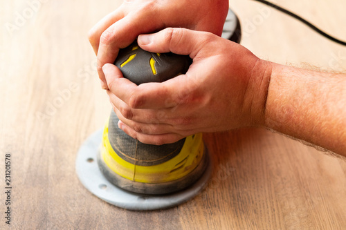 Schilderij op canvas Closeup of hands holding a manual grinding machine