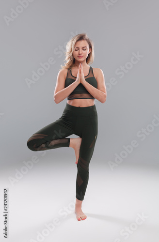 Meditating woman balancing on one leg