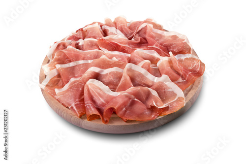 Round chopping board with sliced Parma ham