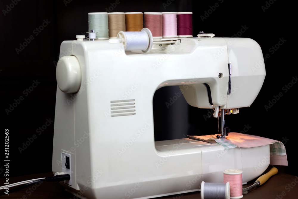 Close up sewing fabric with white sewing machine