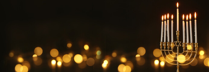 image of jewish holiday Hanukkah background with menorah (traditional candelabra) and candles.