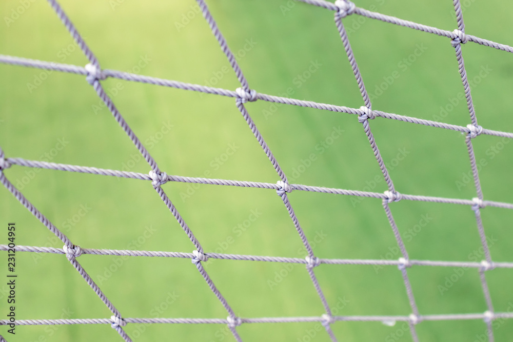 Football net close up on green grass football field background Football net close up on green grass football field background