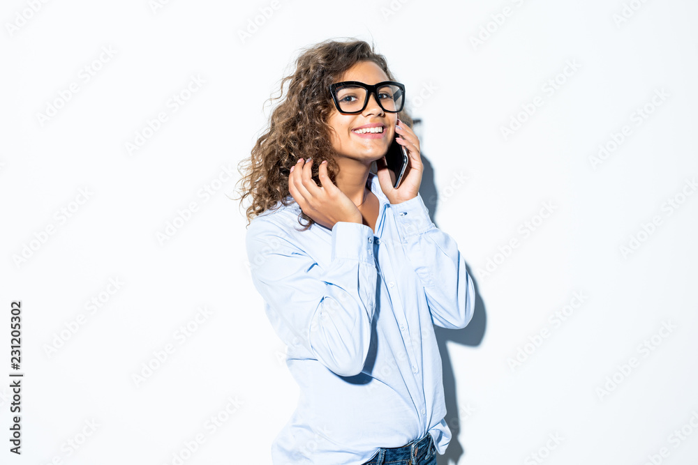 Young curly latin woman in glasses and formal wear talking phone isolated on white background Young curly latin woman in glasses and formal wear talking phone isolated on white background