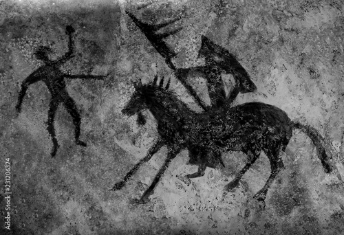 the image of an ancient hunter on the cave wall. history of antiquities. epoch, archaeology.