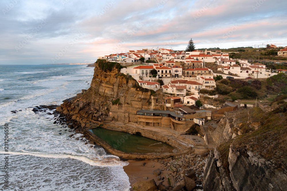 View of the Picturesque village Azenhas do Mar, on the edge of a cliff with a beach below. Landmark near Sintra, Lisbon, Portugal, Europe. landscape at sunset.