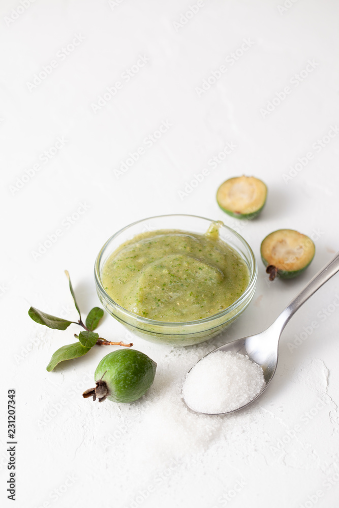 Fresh raw fruits of feijoa grated with sugar on white Fresh raw fruits of feijoa grated with sugar on white