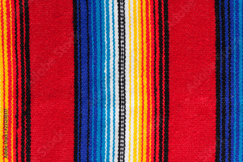 Detail of traditional handmade mexican serape with stripes in vibrant traditional mexican colors photo