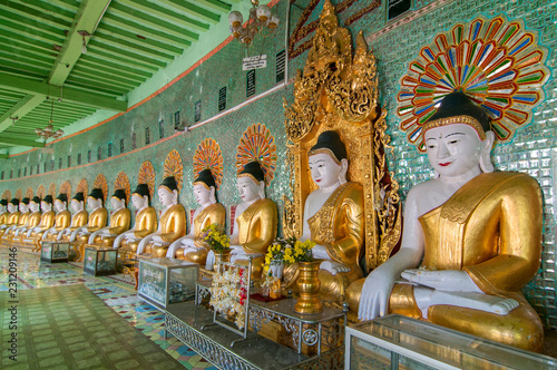 Many seated Buddha sculptures, walls decorated with glass mosaics, Umin Thounzeh, Umin Thonse or U Min Thonze Pagoda, Sagaing Hills near Mandalay, Myanmar. photo