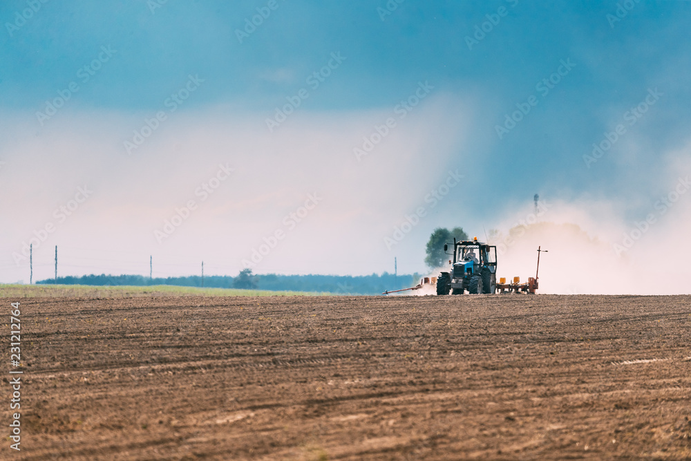 Fototapeta premium Tractor Plowing Field In Spring Season. Beginning Of Agricultura
