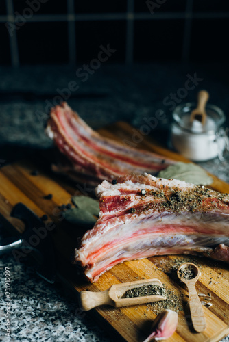  raw meat on wooden cutting board on dark background