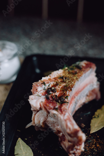  raw meat on in a metal box on dark background