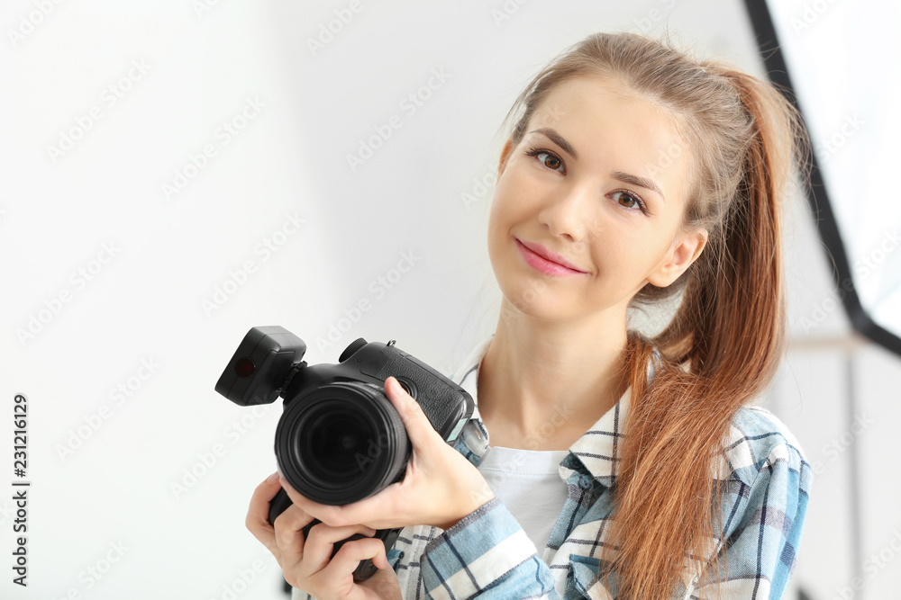 Young female photographer working in studio Young female photographer working in studio