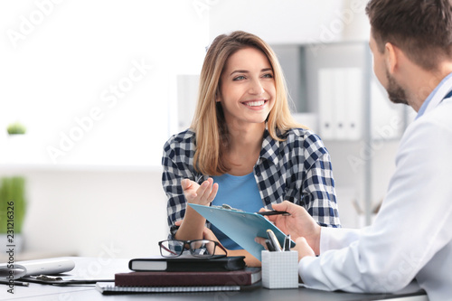 Doctor consulting female pa...