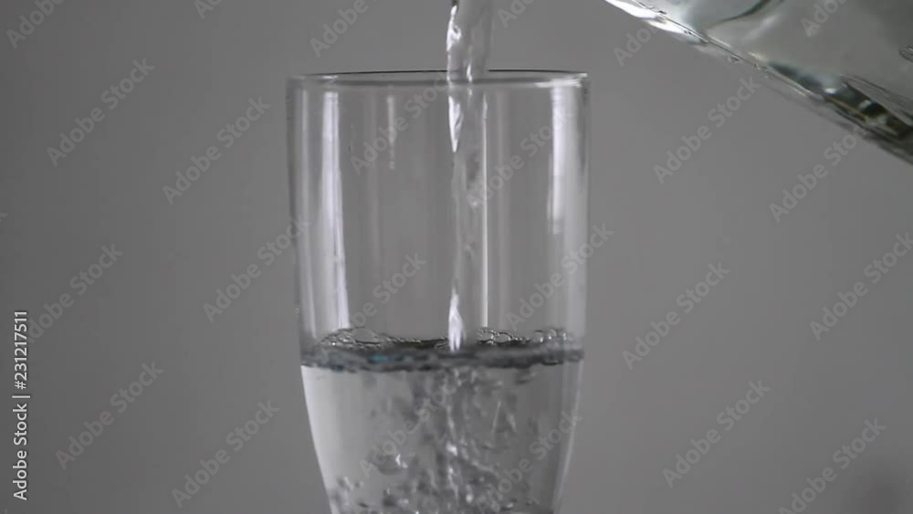 Serving water in a glass with white background