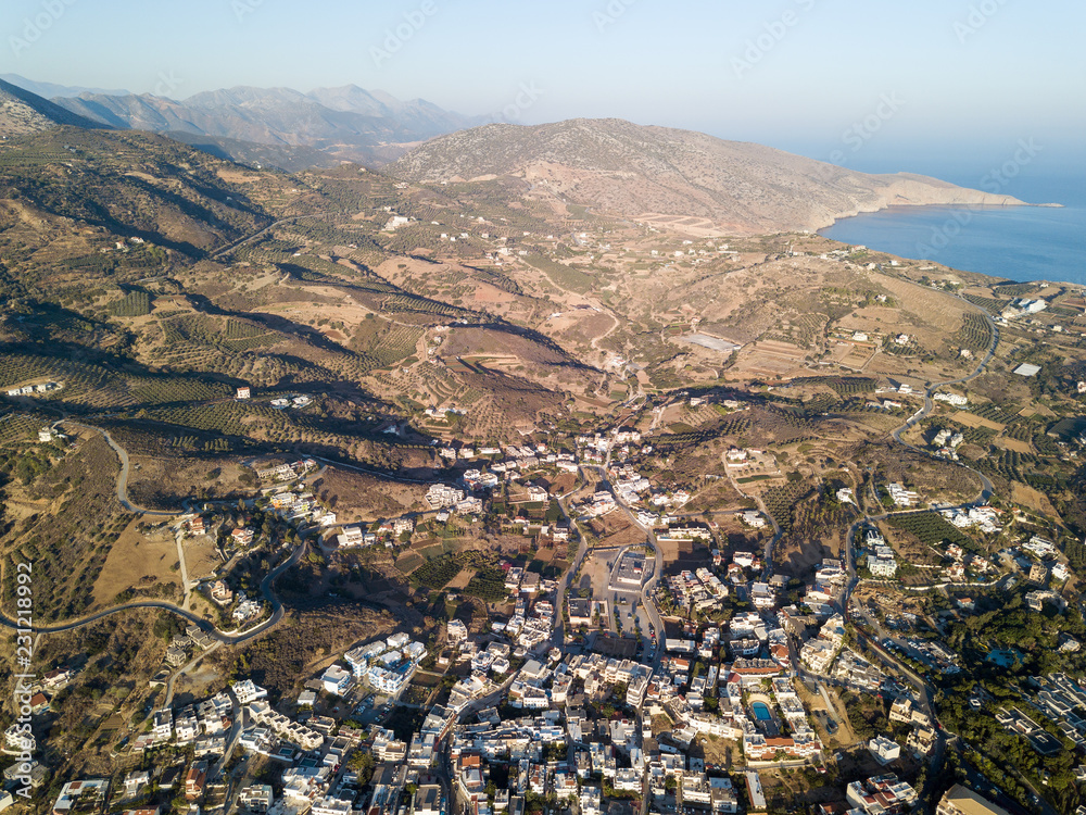 Aerial drone photo of beautiful bay with sandy beach and cretan village of Agia Pelagia, Greece