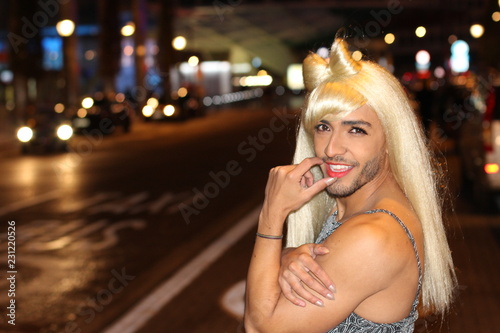 Fotografie Muscular transvestite with beard and blonde wig