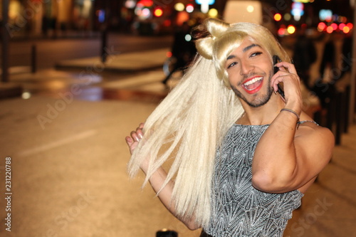 Bearded transvestite calling by phone outdoors  photo