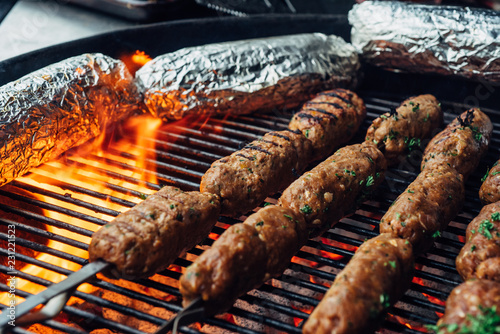 Beef kebabs on a grill with a flare-up