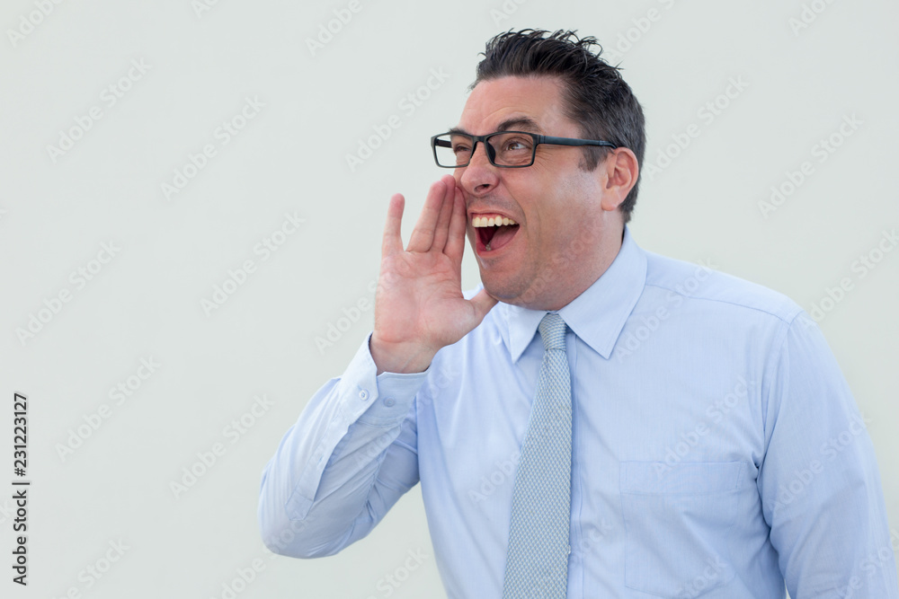 Emotional businessman screaming loudly. Positive handsome man in formal shirt keeping hand near mouth and making announcement. News concept Emotional businessman screaming loudly. Positive handsome man in formal shirt keeping hand near mouth and making announcement. News concept