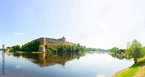 Beautiful city landscape. Medieaval aged castle and river. Blue sky with clouds