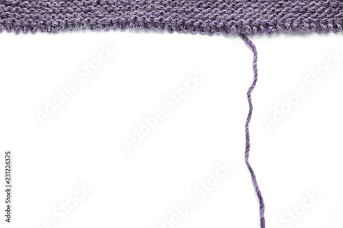 Cuadro en lienzo Unravelling knitted fabric on white background