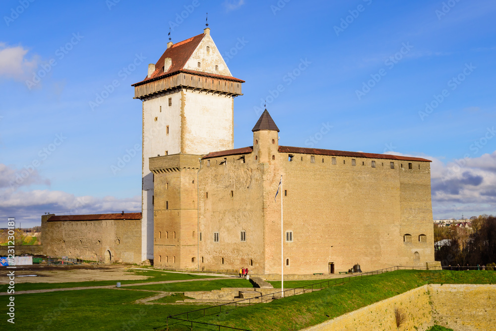 Sightseeing of Estonia. Beautiful autumn view of Narva Castle with tall Herman's tower
