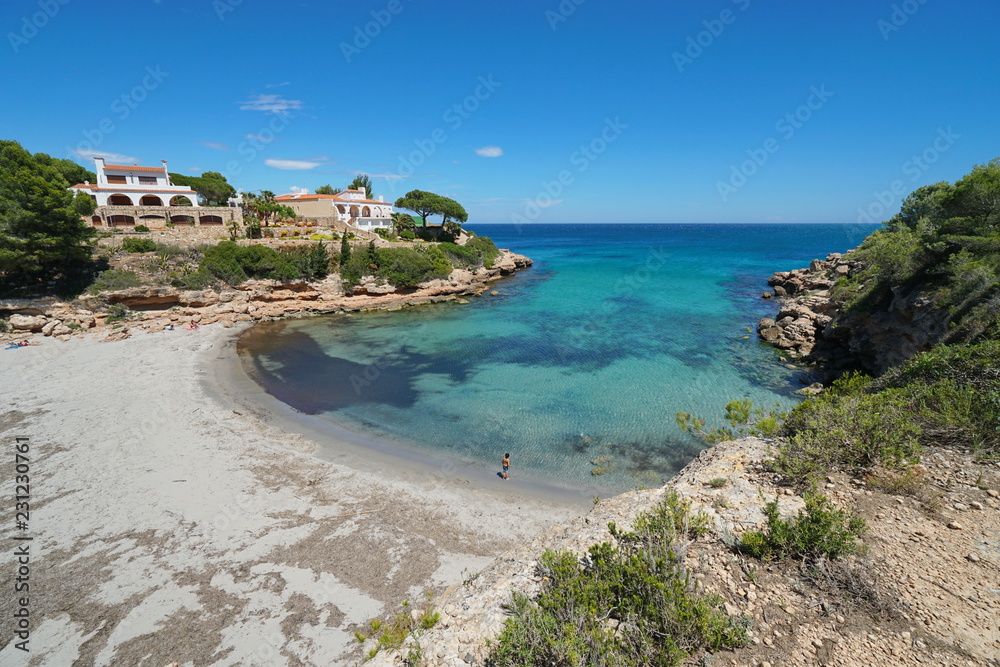 Spain Costa Dorada peaceful cove with sandy beach and coastal houses, Mediterranean sea, Cala Estany Tort, Catalonia, L'Ametlla de Mar, Tarragona