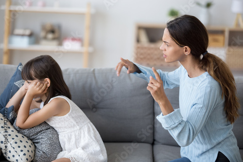 Canvas-taulu Side view single mother screams shouts at little daughter scolding her